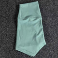 Women's high-waisted nylon yoga shorts in a selection of colours on a neutral background.
