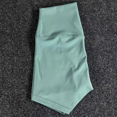 Women's high-waisted nylon yoga shorts in a selection of colours on a neutral background.
