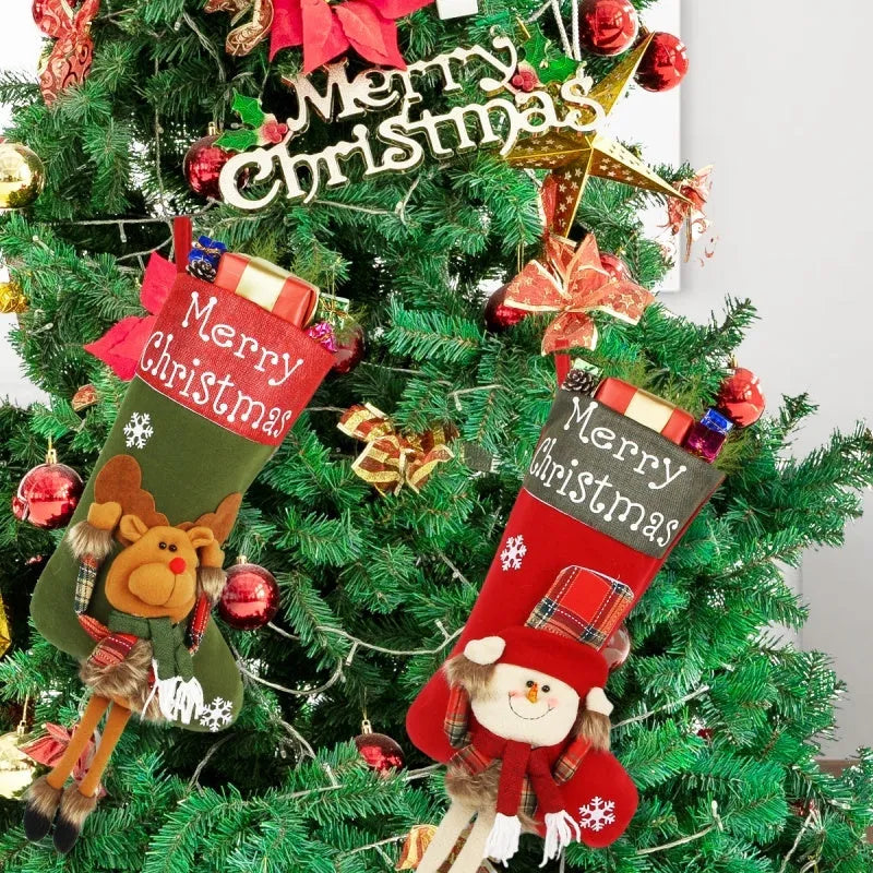 Three large Christmas stockings with 3D Santa, snowman, and reindeer designs hung on tree