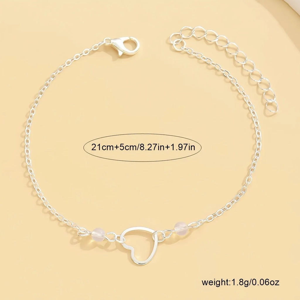 Adjustable women's anklet with heart-shaped pendant in gold or silver finish