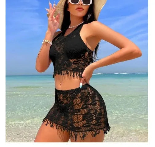 Women's white lace bikini top with matching tassel skirt two-piece swimsuit set on beach