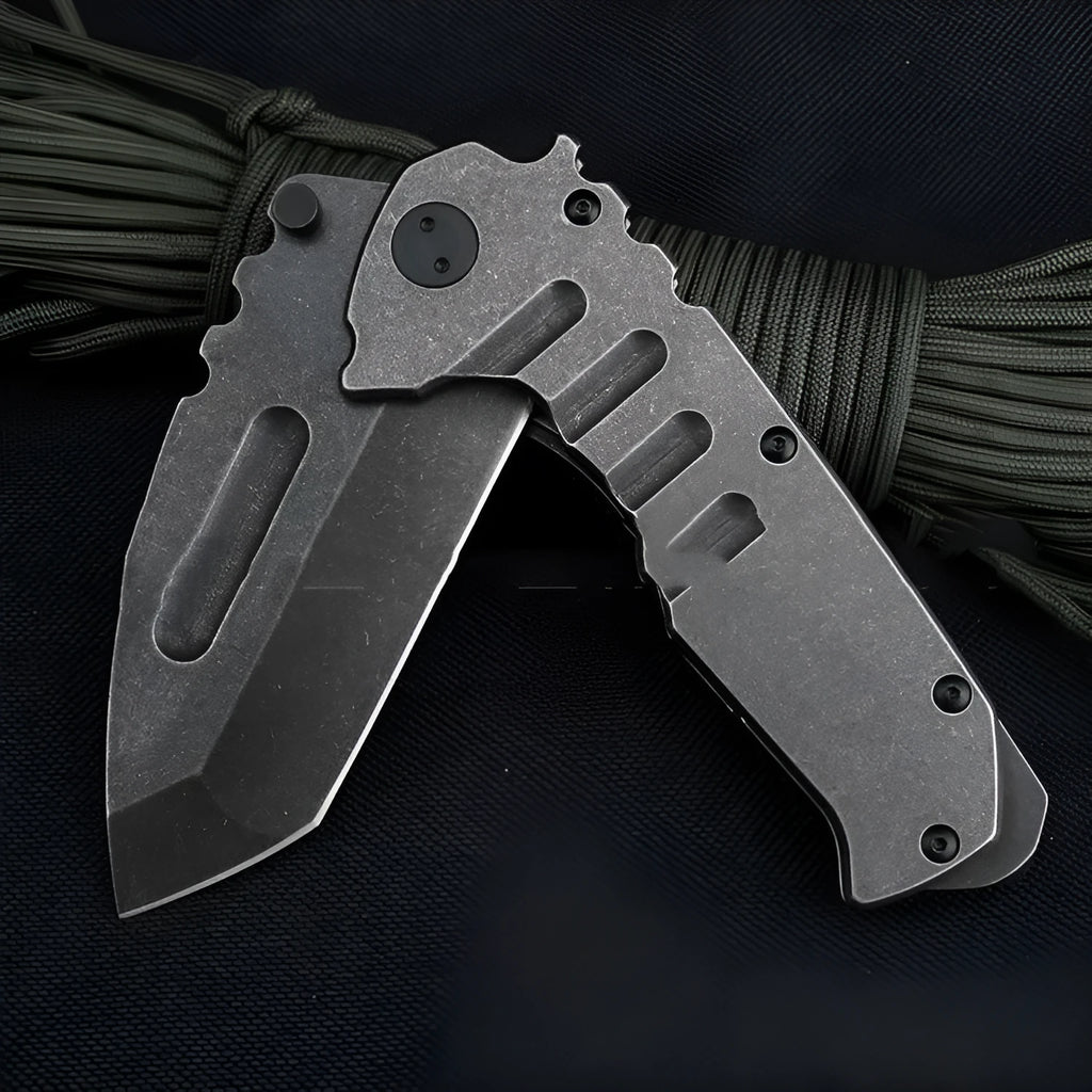 907 style outdoor folding knife with D2 steel blade, 9 cm blade, black handle, closed position on grey background