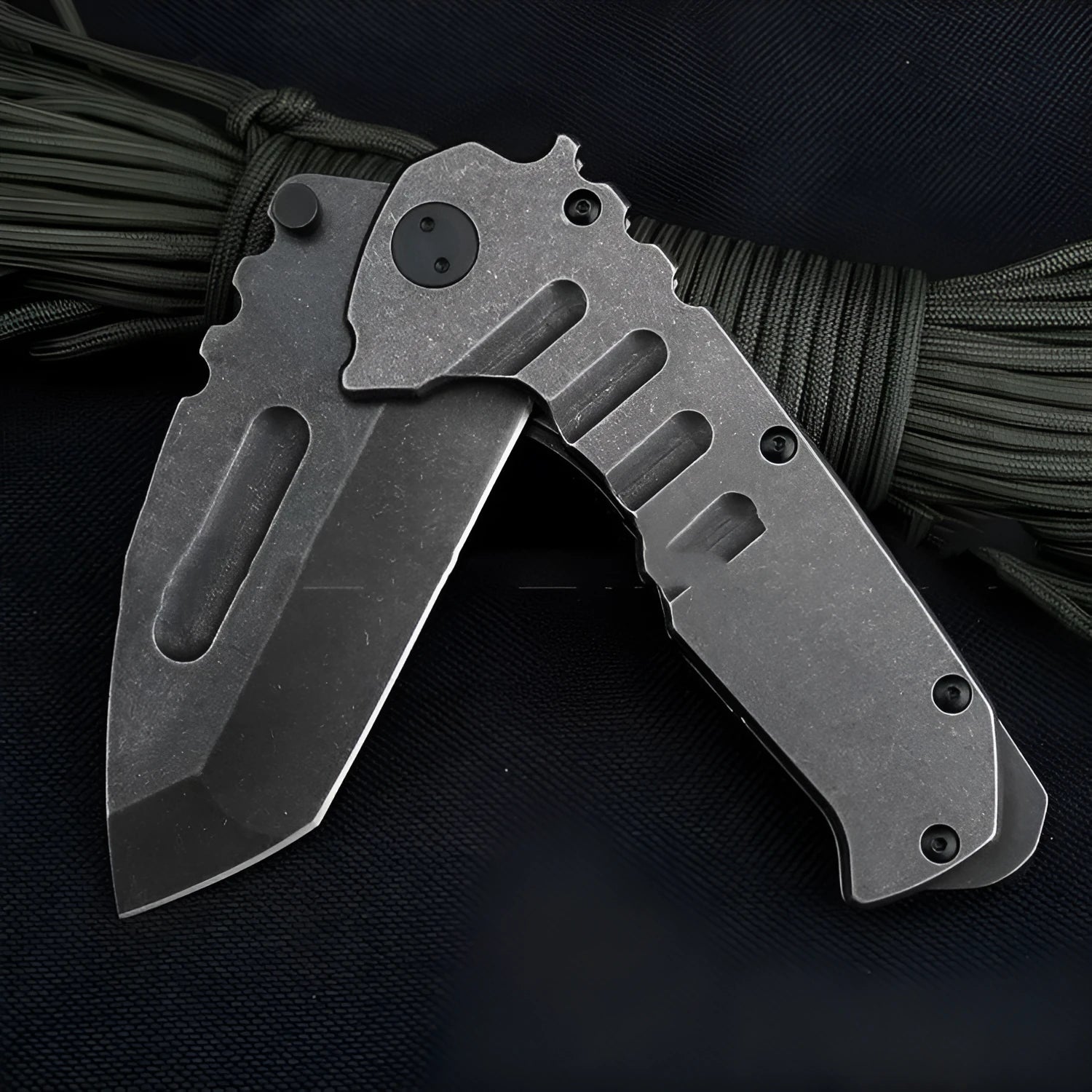 907 style outdoor folding knife with D2 steel blade, 9 cm blade, black handle, closed position on grey background