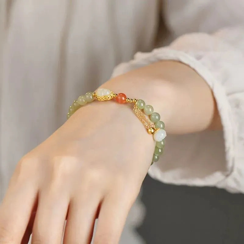 Jade women's bracelet with gold-plated gourd charm and fu character traditional design elements