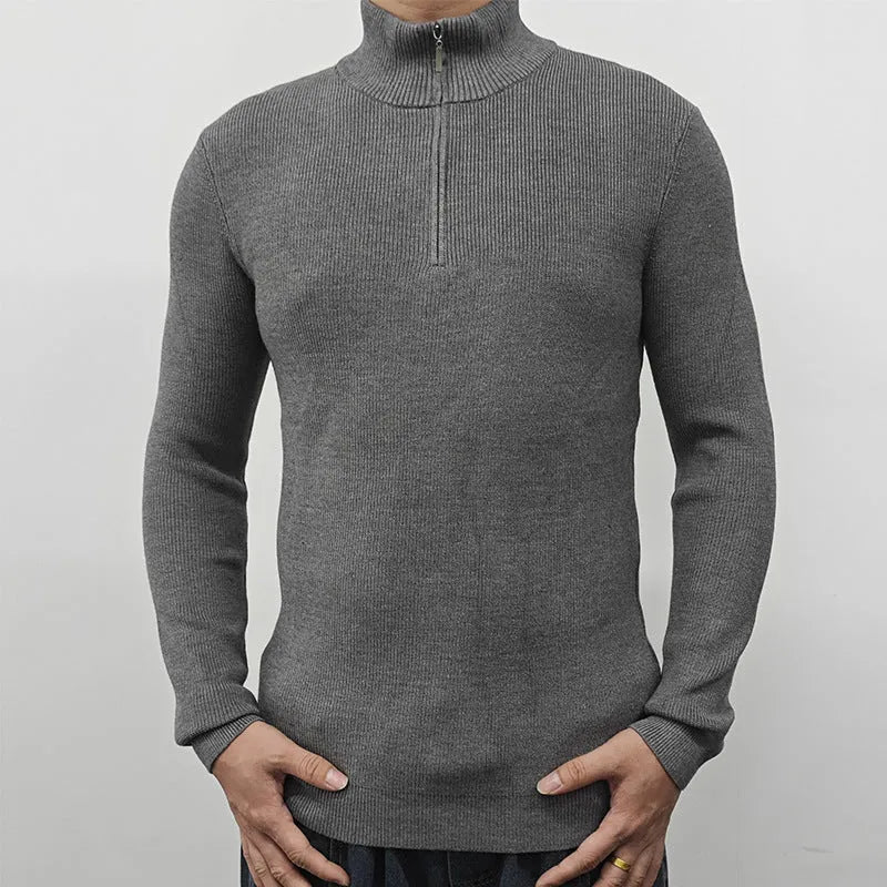 Men's black half-turtleneck zip sweater on a hanger, showing long sleeves and zip front detail.