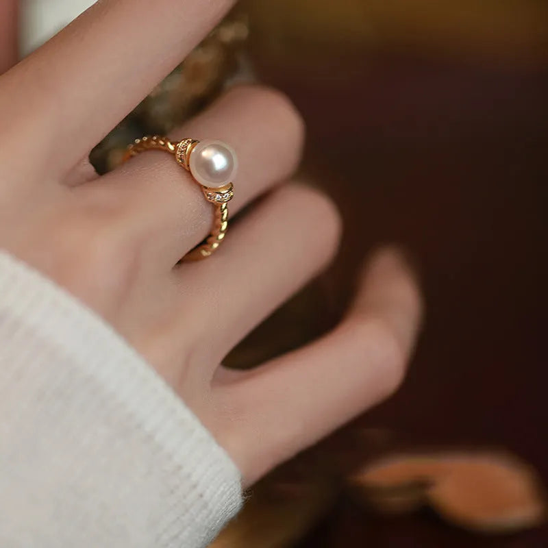 Adjustable copper ring with pearl inlay in gold or silver finish and antique twist design.