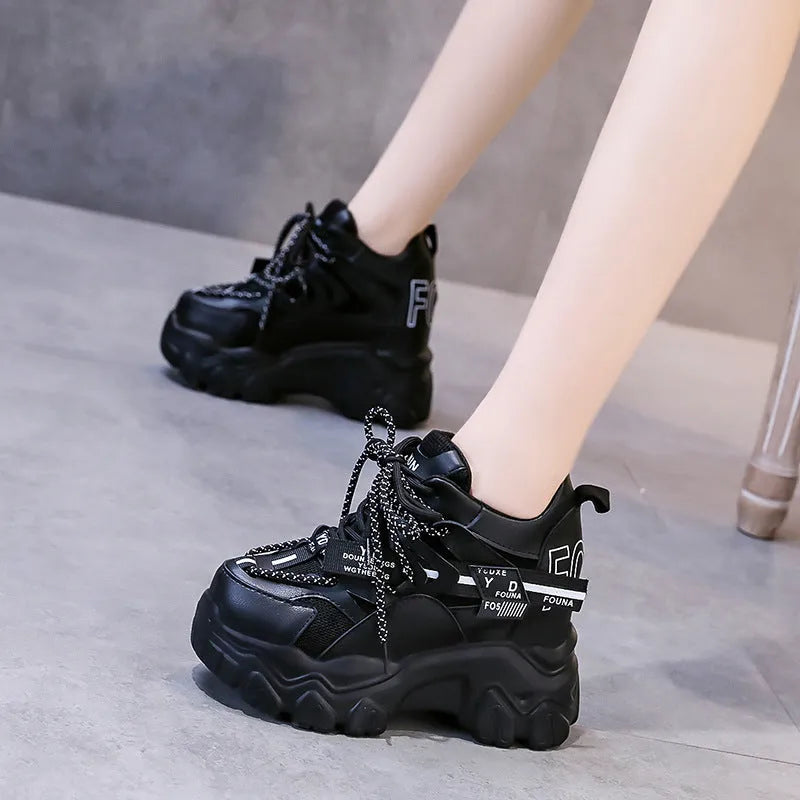 Women's white and black breathable mesh platform sports shoes with cross-strap and rubber sole.
