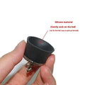 Black TPR golf ball suction cup picker with conventional size on a green surface