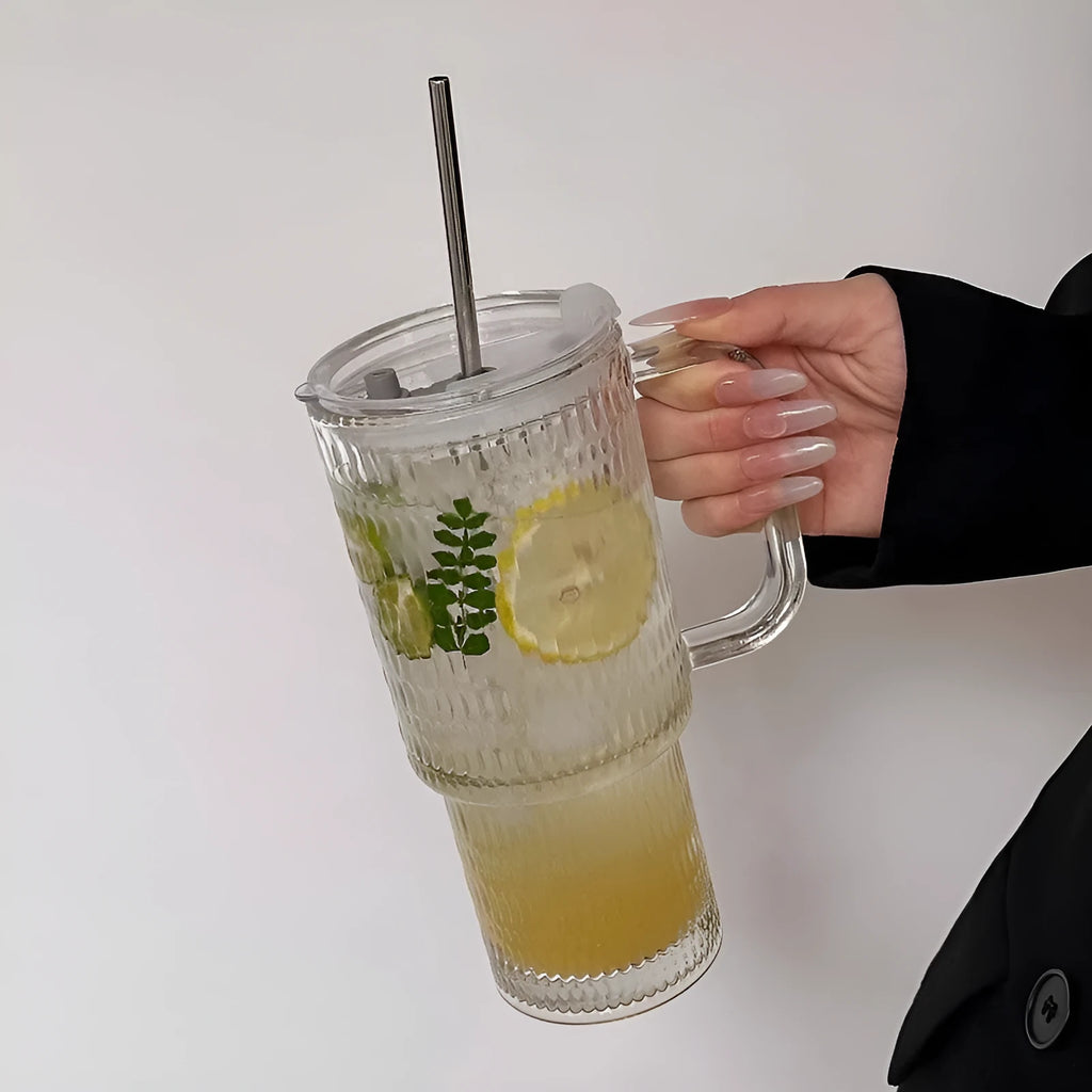 740ml round glass cup with handle, lid, and bent straw on modern table setting