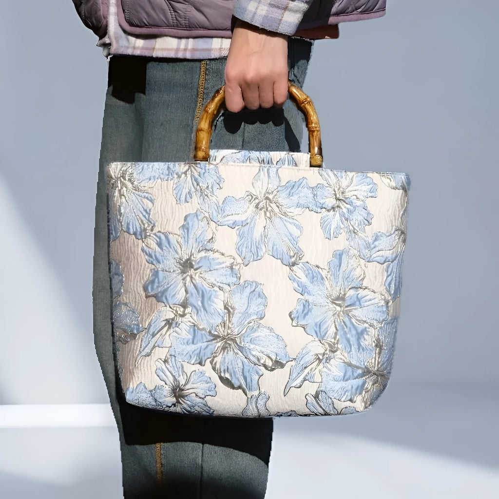 Light blue canvas shoulder bag with gold floral decoration and double shoulder straps