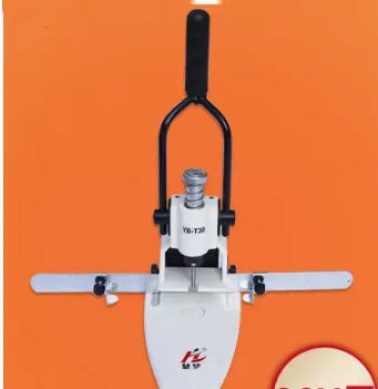 T30 single hole manual punching machine on a desk with paper stack inserted, adjustable edge guide visible