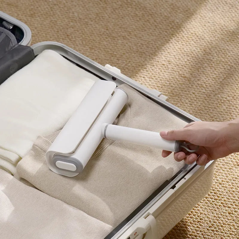 Long-handle lint roller with removable adhesive head for picking up pet hair from floors and furniture