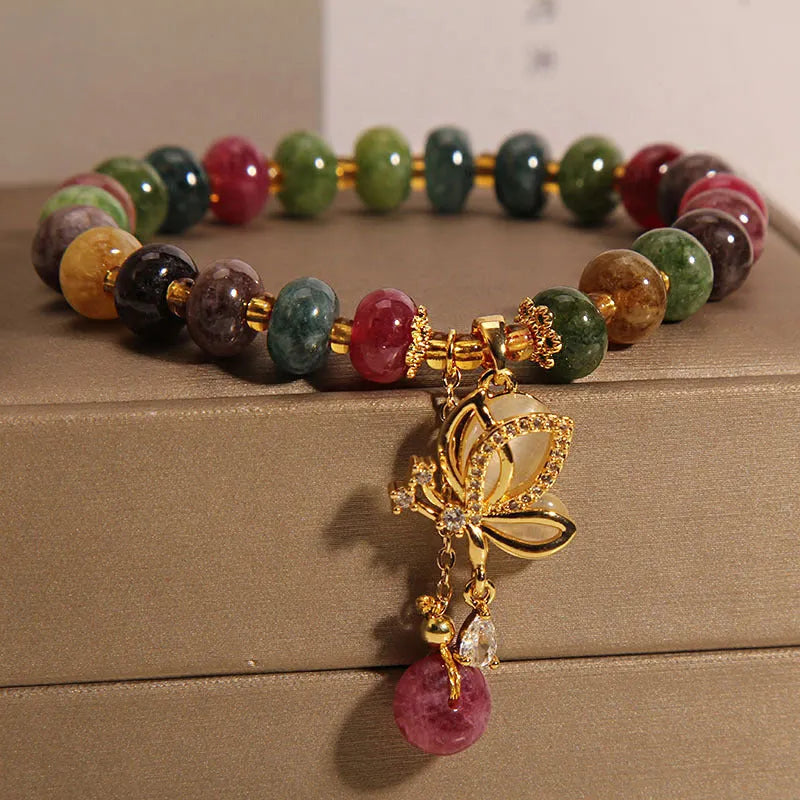 Colourful women's bracelet with butterfly charm and bead accents on alloy band