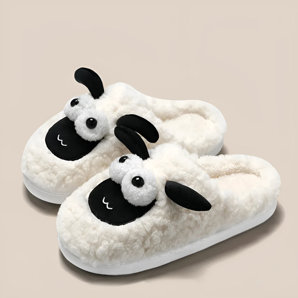 Brown lamb thermal cotton slip-on slippers with suede upper on a wooden floor.