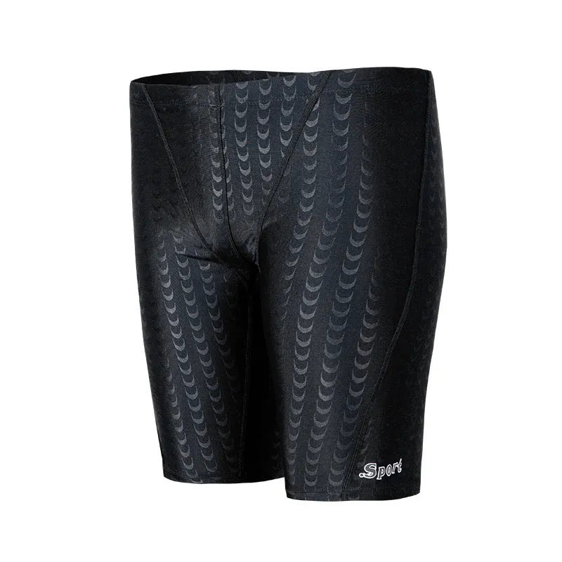 Men's solid colour swimming trunks in shark skin polyester fabric for surfing.