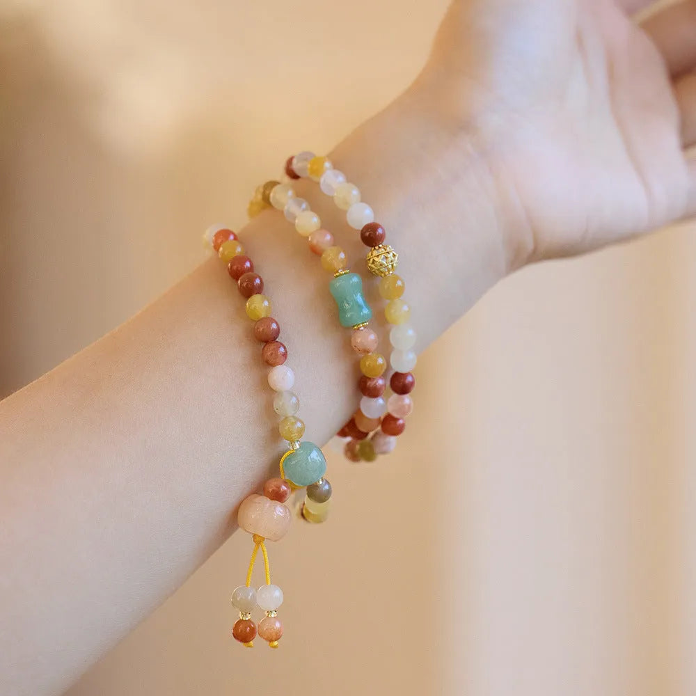 Women's green jinsi jade bracelet with golden threads and pumpkin tassel design