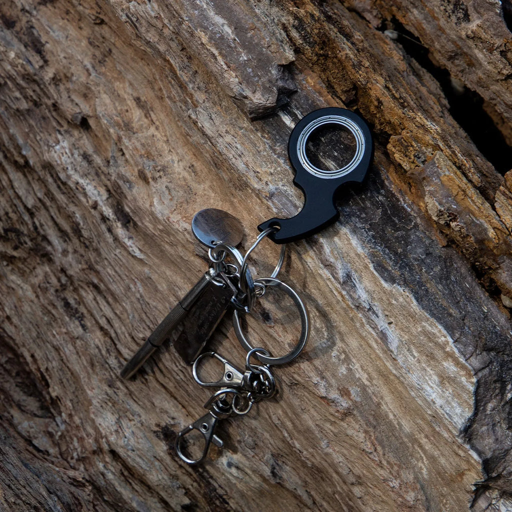 Creative fidget spinner keychain in black with plastic and zinc alloy construction, featuring a bottle opener