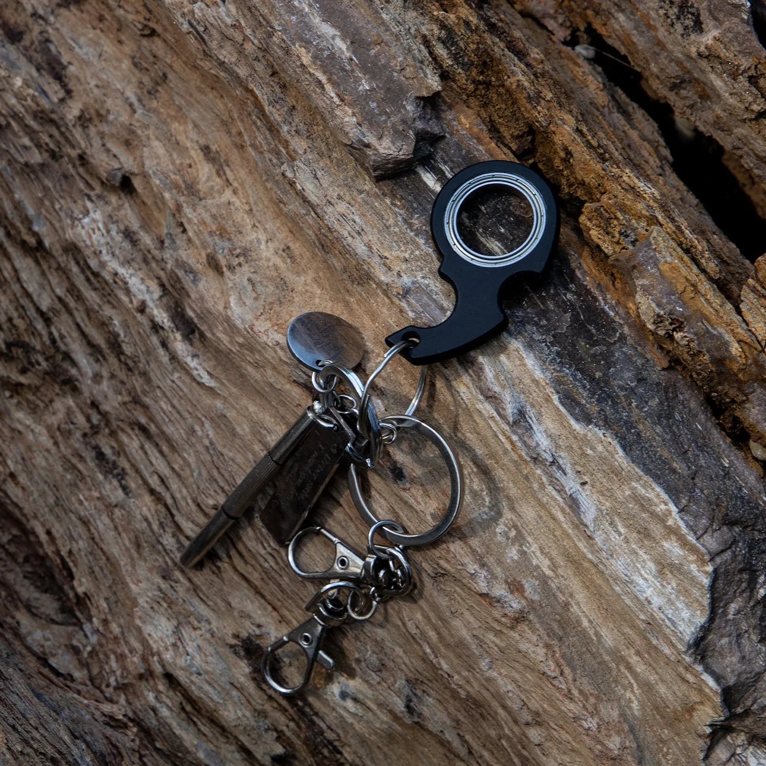 Creative fidget spinner keychain in black with plastic and zinc alloy construction, featuring a bottle opener