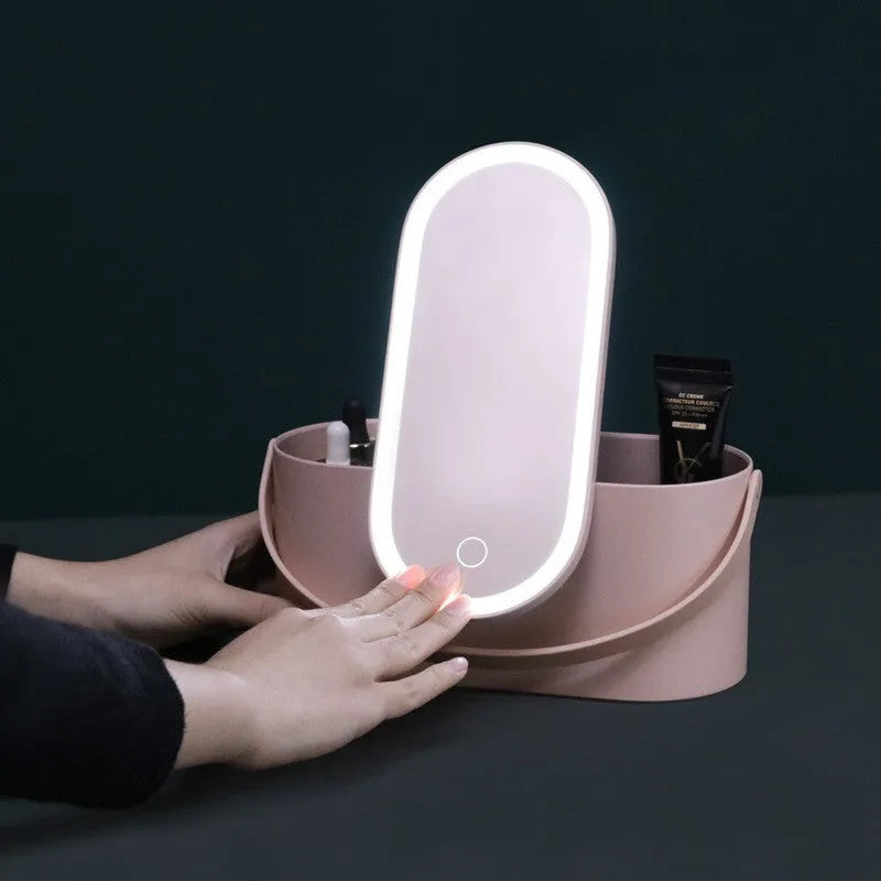 Pink portable makeup storage box with LED illuminated aluminium mirror and cosmetic compartments