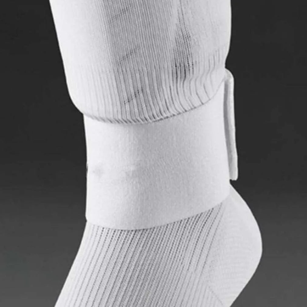 Red elastic rubber strap for securing football shin guards, shown at approximate size.