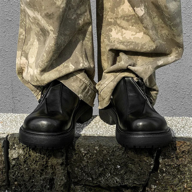 Black platform leather-style shoes with round toe and low top for height increase.