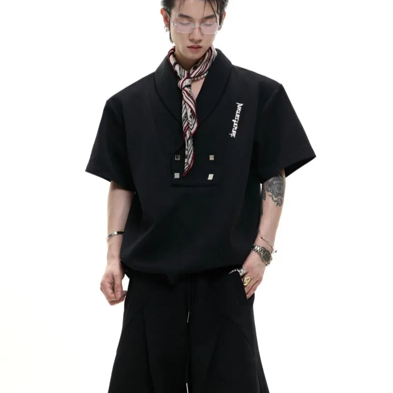 Men's dark grey V-neck short sleeve cotton sports jacket with padded shoulders and metal details, paired with matching shorts.