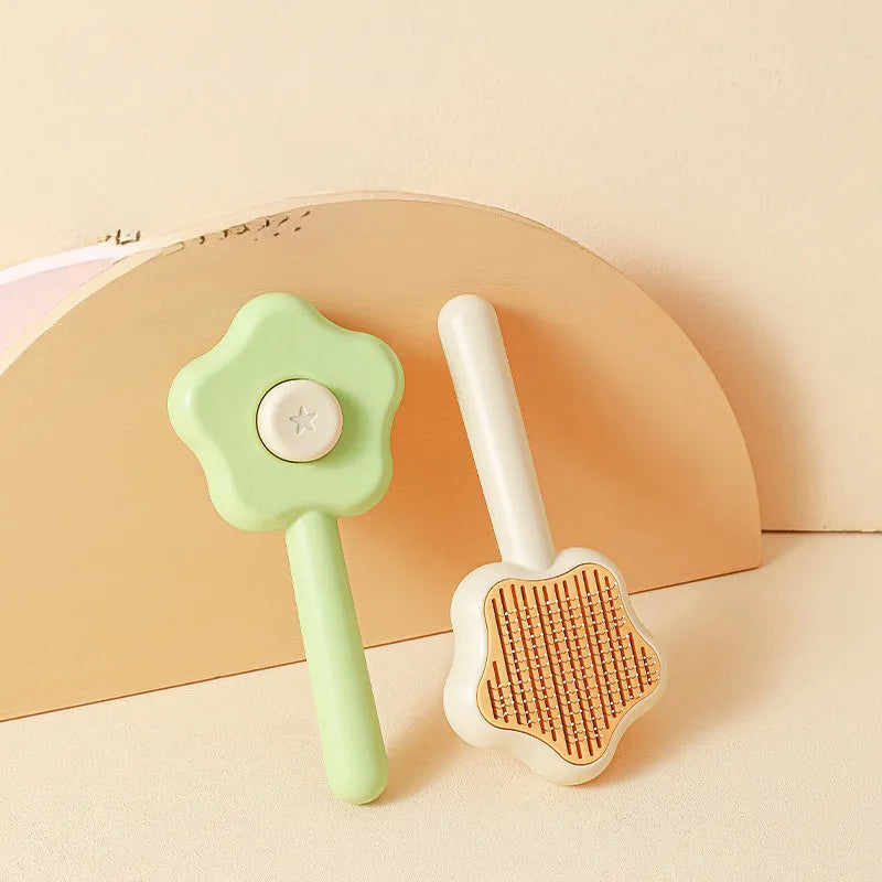 Self-cleaning stainless steel pet comb with green handle, showing the 20cm length and needle teeth