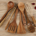 Natural wood 7-piece cooking utensil set for non-stick pans on a kitchen counter.