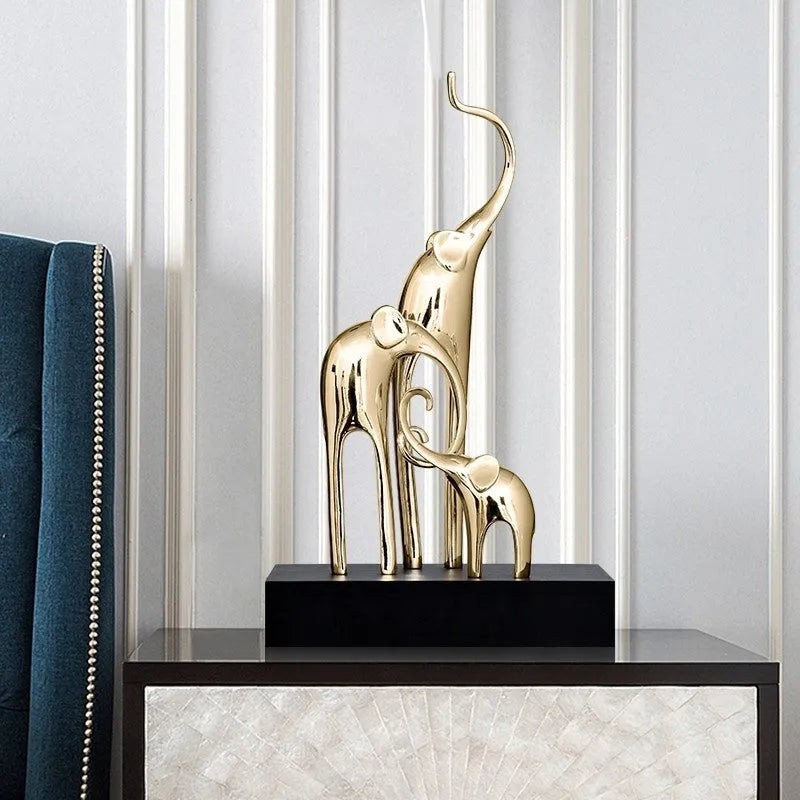 Fortune Bring Elephant decorative resin statue in gold on a wooden shelf.