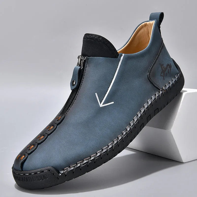 Men's black leather martin boots with a front metal zipper and round toe on a rubber sole.