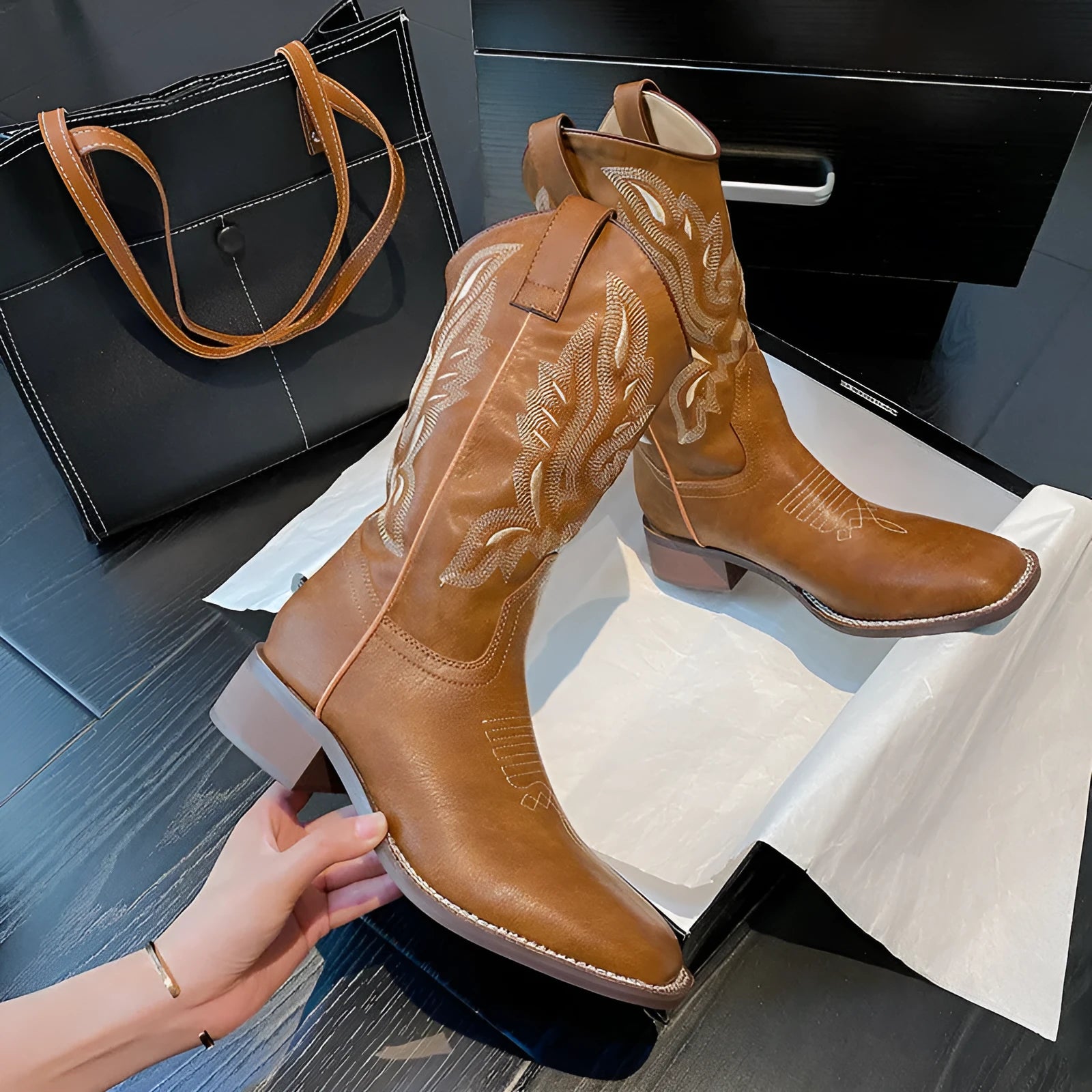 Brown embroidered women's mid-calf Martin boots with a square heel on a white background.