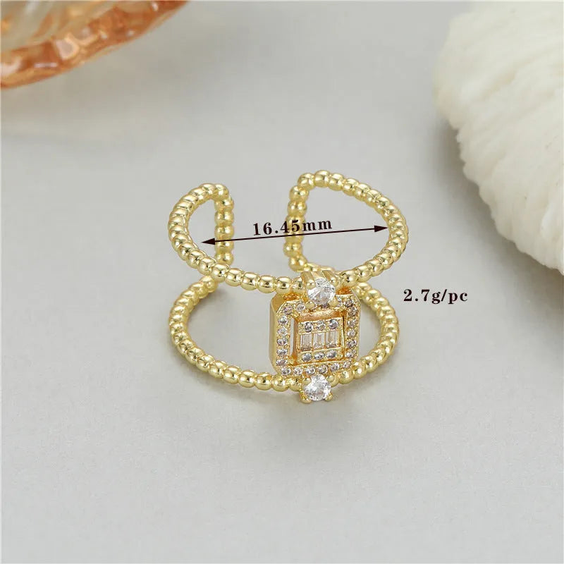 Gold-plated copper open ring with asymmetric U-shape and adjustable gap.