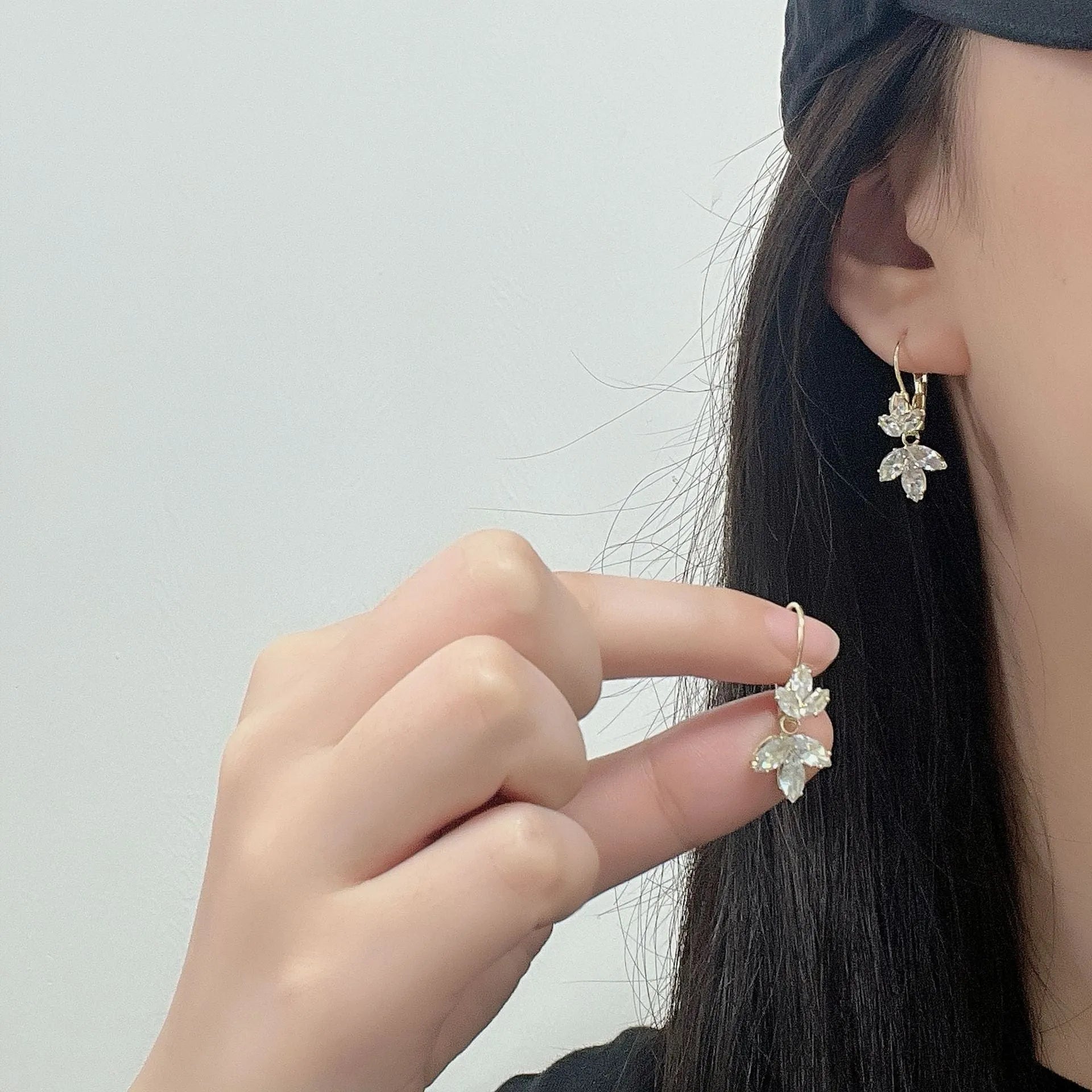 Platinum colour leaf earrings with shiny inlaid zircon stones