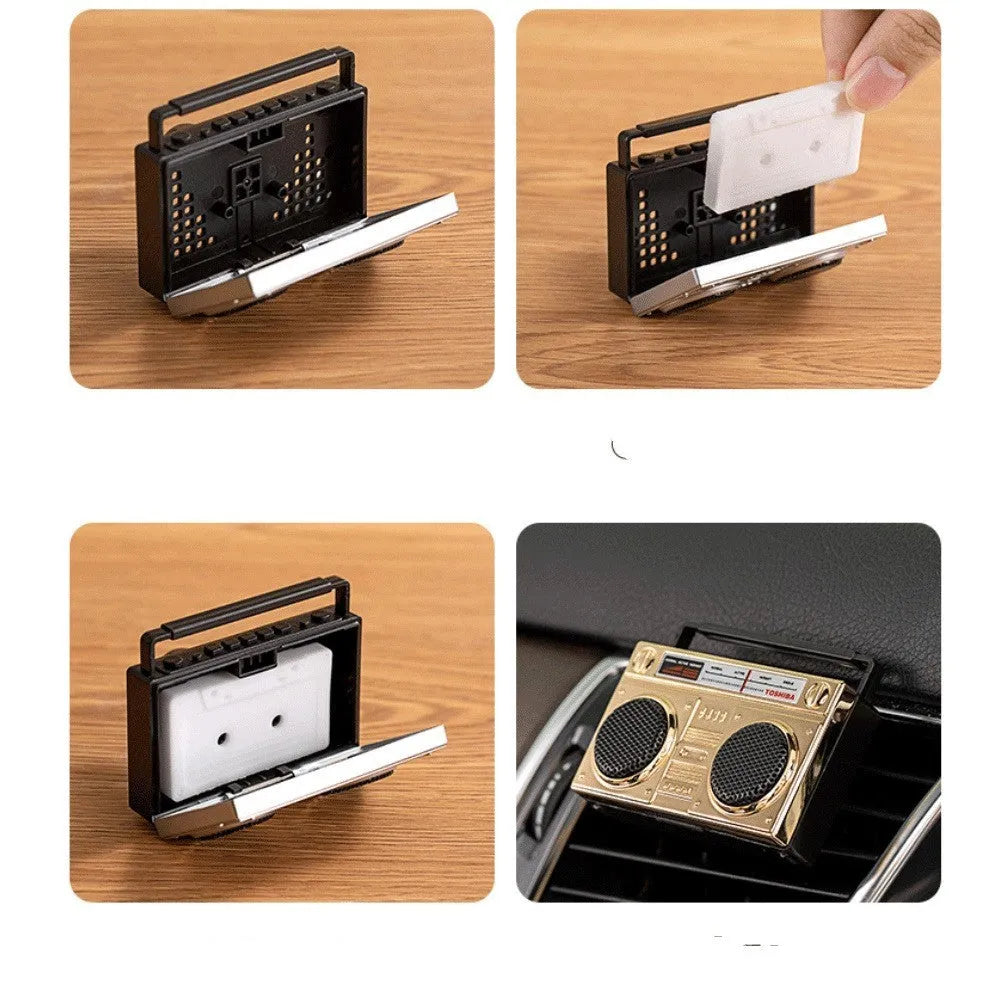 Gold retro cassette tape recorder car air freshener diffuser on a car vent.
