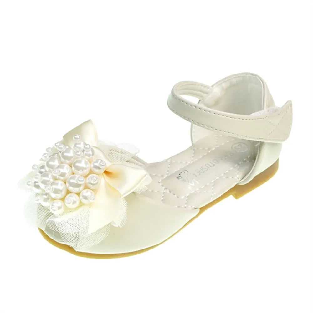 Girls princess peep toe sandals with pearl flower decoration in beige colour on display