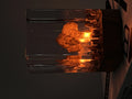 Small atomic bomb mushroom cloud shaped resin night lamp decoration in two colour variants on a dark surface.