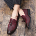 Men's black formal slip-on shoe with pointed toe and decorative tassel on artificial PU upper.
