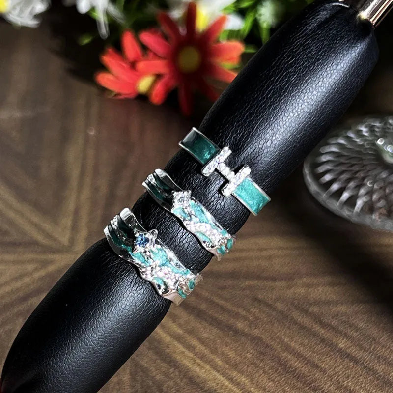 Mint green enamel ring with asymmetrical folded eight-point star design on copper band