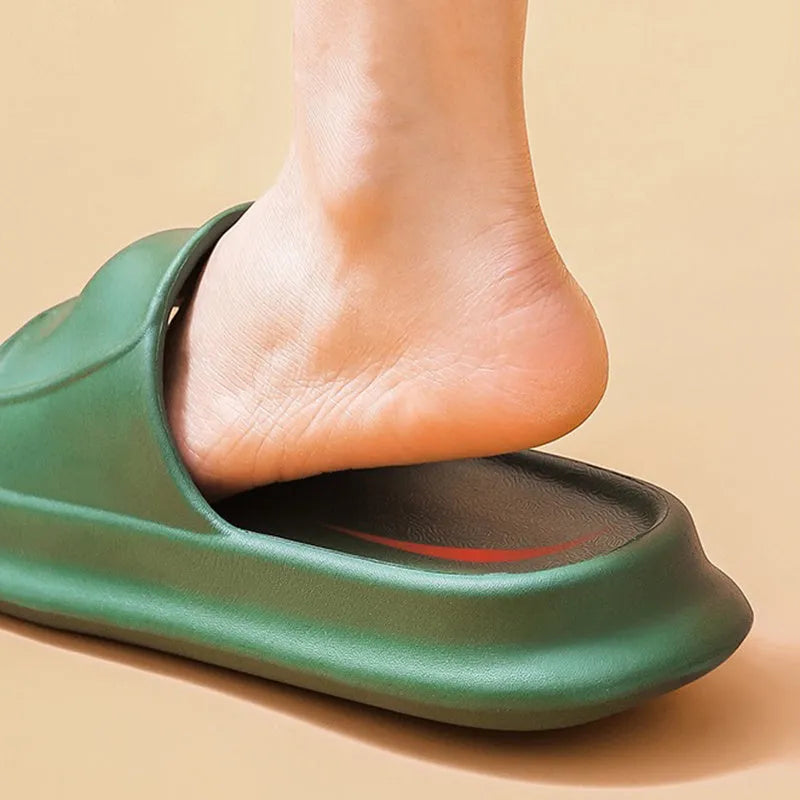 Pair of thick-soled EVA flip-flop slippers in a chosen colour on a bathroom floor.