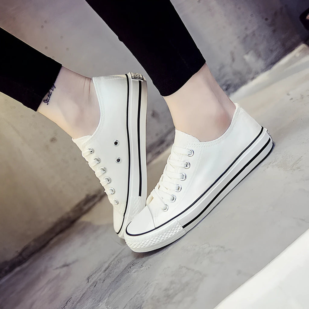 Women's canvas casual shoes in solid colours showing black, white black, white red, and all black options