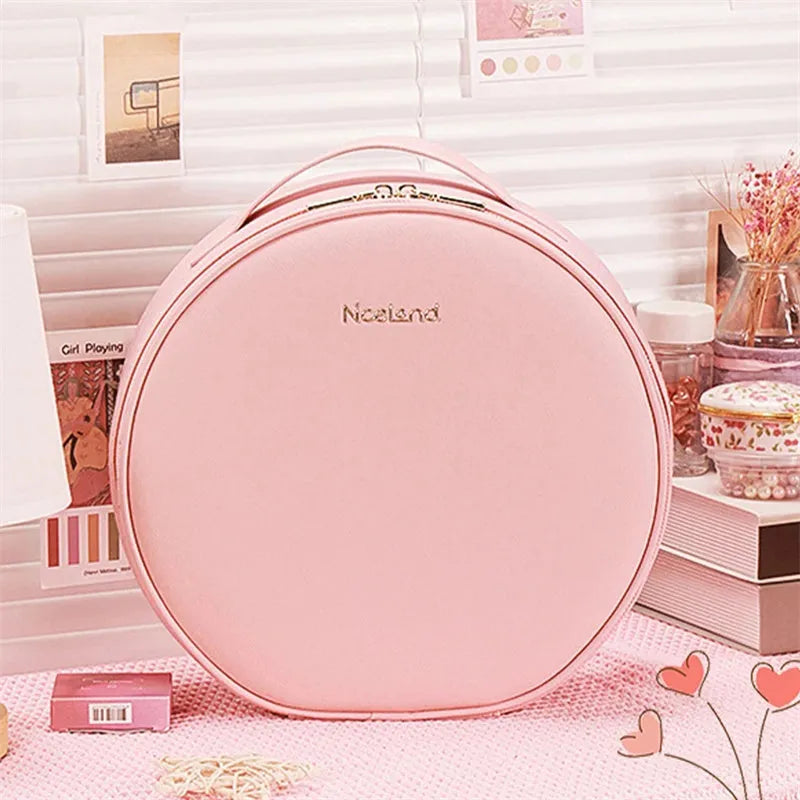 Round pink PU leather makeup bag with built-in LED illuminated mirror and internal cosmetic partitions open.