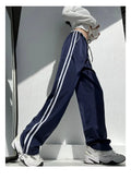 Women's navy blue loose straight pants with white contrast ribbon parallel bars detail and low waist
