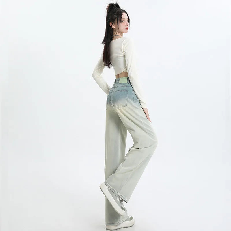 Gradient blue straight-leg denim trousers for women on a hanger, showing the wide-leg cut and colour fade.