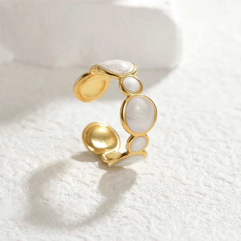 A geometric stainless steel ring for women with an adjustable opening and electroplated finish.
