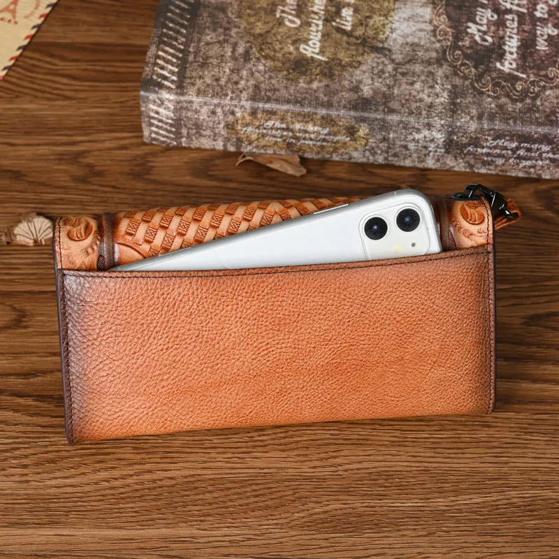 Women's brown tri-fold leather wallet with an embossed floral pattern, shown open to reveal compartments.