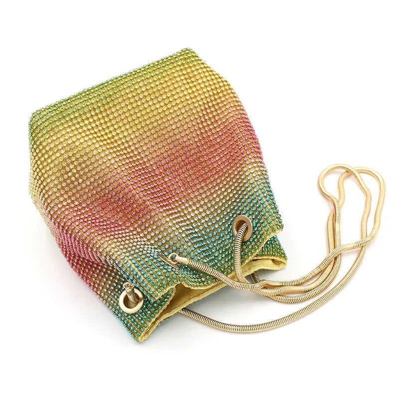 Colourful rainbow rhinestone bucket bag with a single shoulder strap.