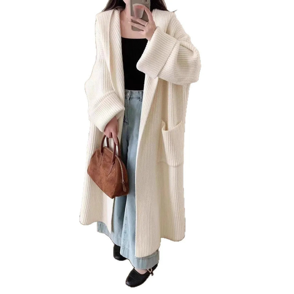 Loose grey hooded cardigan coat for women with long sleeves on a hanger.