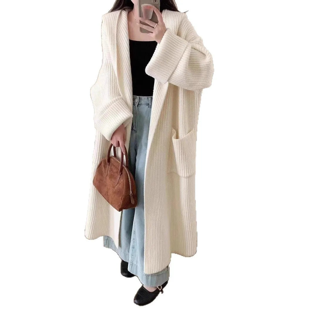Loose grey hooded cardigan coat for women with long sleeves on a hanger.