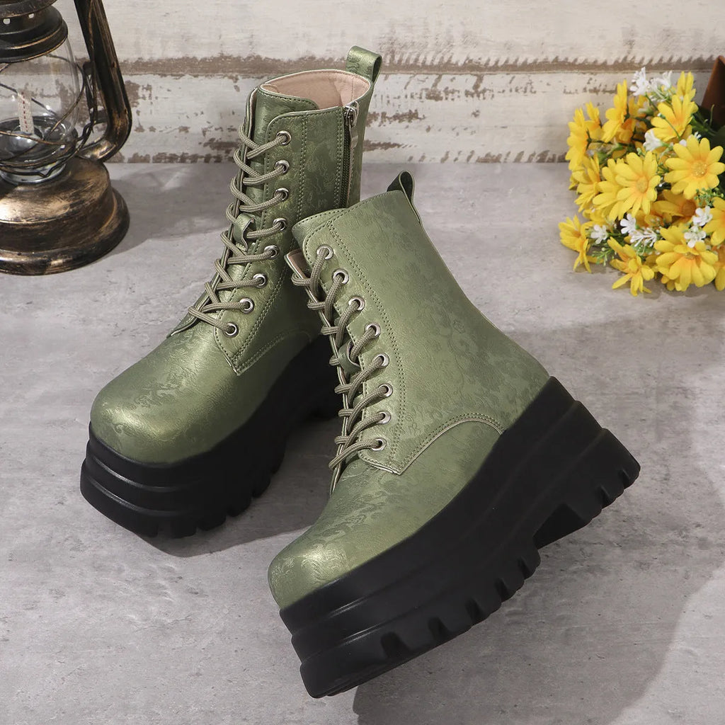 Women's black platform Martin boots with patchwork detail and side zip on a white background.