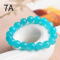 Loose polished Grade 7A Amazonite beads in various sizes on a white background.